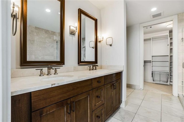 bathroom with vanity and a shower