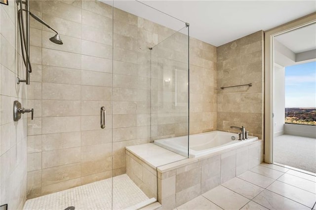 bathroom featuring tile patterned floors and independent shower and bath