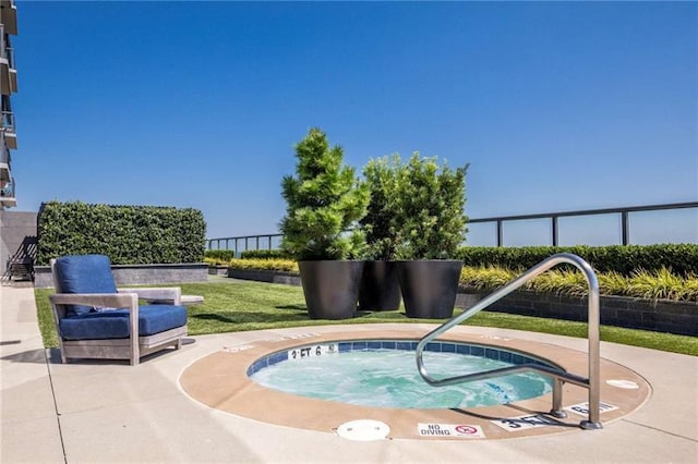 view of pool with an in ground hot tub