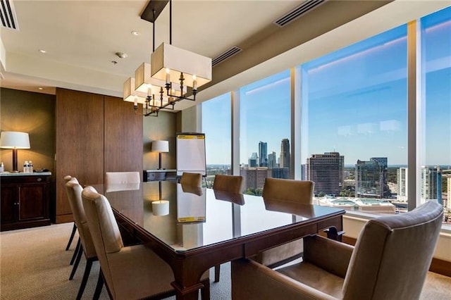 carpeted dining space with plenty of natural light