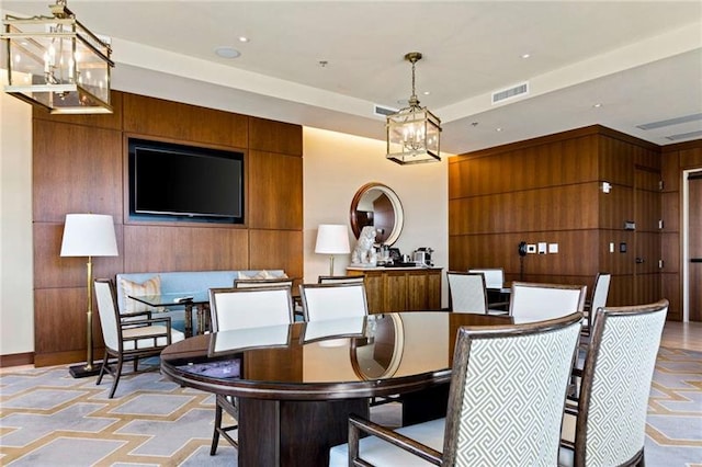 dining room featuring wooden walls