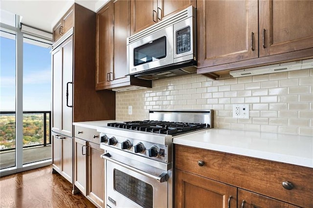 kitchen featuring decorative backsplash, dark wood-type flooring, and appliances with stainless steel finishes