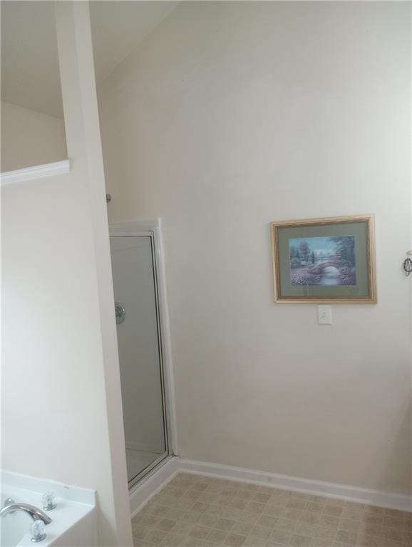 102 Ozark Trl, Canton, GA 30114 - bathroom featuring baseboards, a stall shower, and a bath