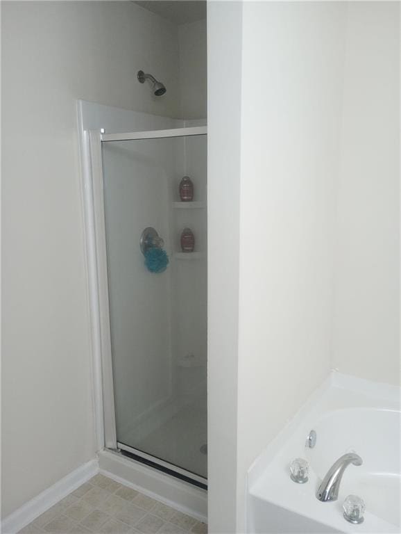 102 Ozark Trl, Canton, GA 30114 - full bathroom featuring a garden tub, a shower stall, and baseboards