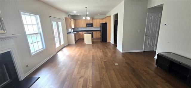 102 Ozark Trl, Canton, GA 30114 - unfurnished living room featuring an inviting chandelier, a healthy amount of sunlight, dark wood finished floors, and a sink