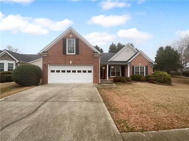 traditional-style house featuring driveway, a front yard, a garage, and brick siding