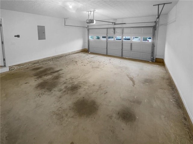 garage featuring electric panel, baseboards, and a garage door opener