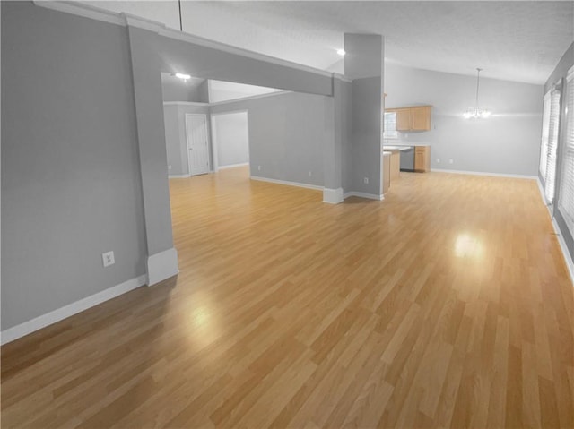 unfurnished living room featuring lofted ceiling, a notable chandelier, light wood-style flooring, and baseboards