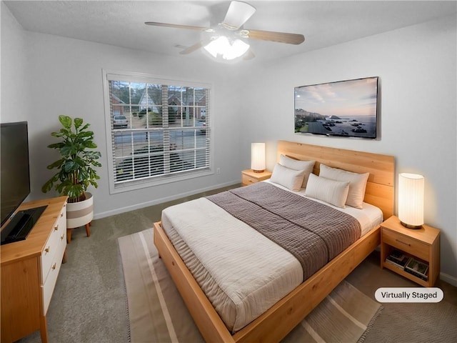 carpeted bedroom featuring baseboards and a ceiling fan