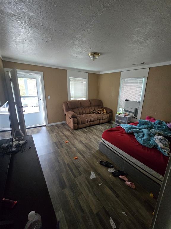 living room featuring hardwood / wood-style flooring and a textured ceiling