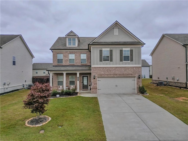 view of front of home featuring cooling unit, a garage, and a front yard