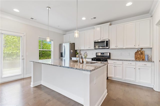 5103 Woodline View Ln, Auburn, GA 30011 - kitchen featuring appliances with stainless steel finishes, wood finished floors, white cabinetry, ornamental molding, and recessed lighting