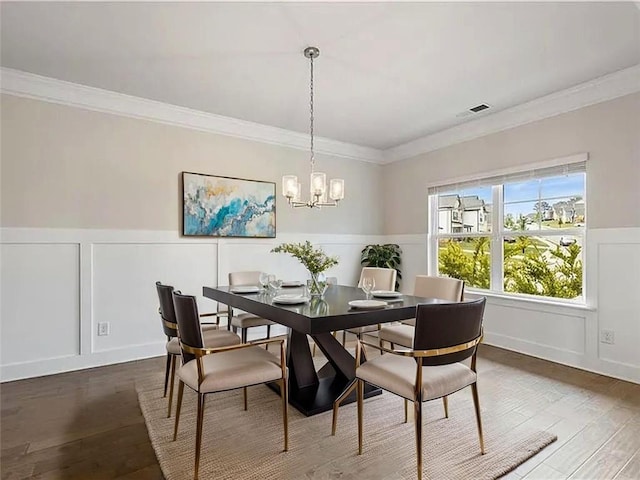 5103 Woodline View Ln, Auburn, GA 30011 - dining room with a decorative wall, hardwood / wood-style floors, a chandelier, ornamental molding, and wainscoting