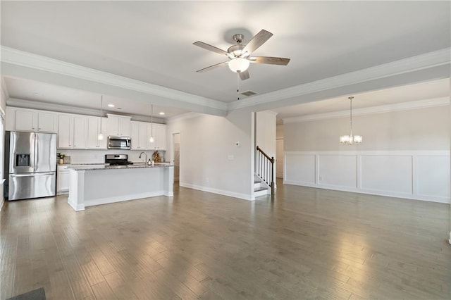 5103 Woodline View Ln, Auburn, GA 30011 - unfurnished living room featuring a chandelier, ceiling fan, dark wood-type flooring, ornamental molding, and stairs