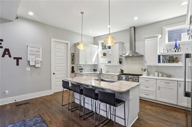2020 Bixby St SE, Atlanta, GA 30317 - kitchen featuring open shelves, wall chimney range hood, a breakfast bar area, white cabinetry, and backsplash