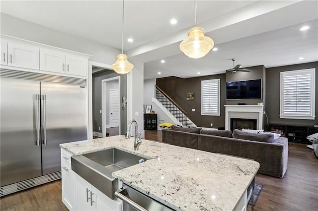 2020 Bixby St SE, Atlanta, GA 30317 - kitchen featuring appliances with stainless steel finishes, dark wood-style flooring, a fireplace, open floor plan, and recessed lighting