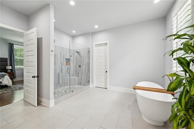 2020 Bixby St SE, Atlanta, GA 30317 - bathroom featuring a shower stall, ensuite bath, recessed lighting, and a freestanding tub