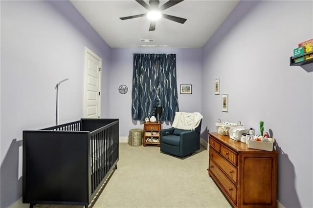 2020 Bixby St SE, Atlanta, GA 30317 - bedroom with a nursery area, light carpet, and a ceiling fan
