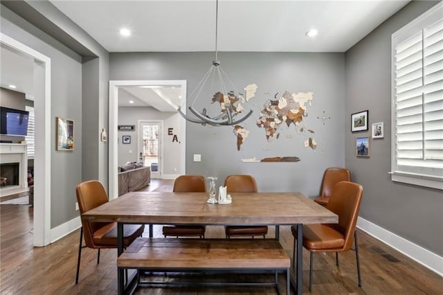 2020 Bixby St SE, Atlanta, GA 30317 - dining space with a chandelier, wood finished floors, a fireplace, and recessed lighting