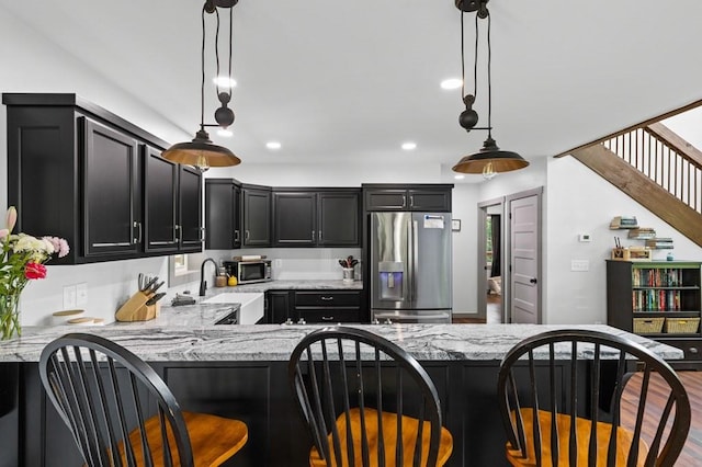 35 Indian Trce, Mineral Bluff, GA 30559 - kitchen featuring appliances with stainless steel finishes, dark cabinets, light stone counters, and recessed lighting