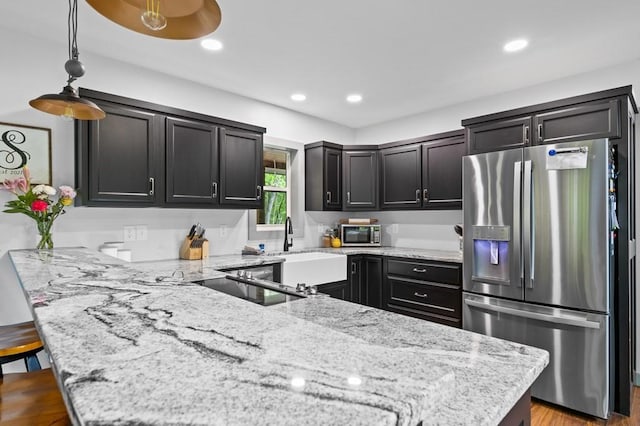 35 Indian Trce, Mineral Bluff, GA 30559 - kitchen featuring stainless steel appliances, a peninsula, light stone countertops, a sink, and recessed lighting