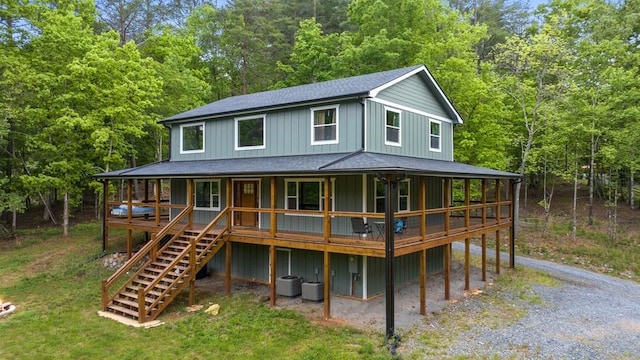 35 Indian Trce, Mineral Bluff, GA 30559 - rear view of house featuring roof with shingles, a wooded view, stairway, covered porch, and central AC