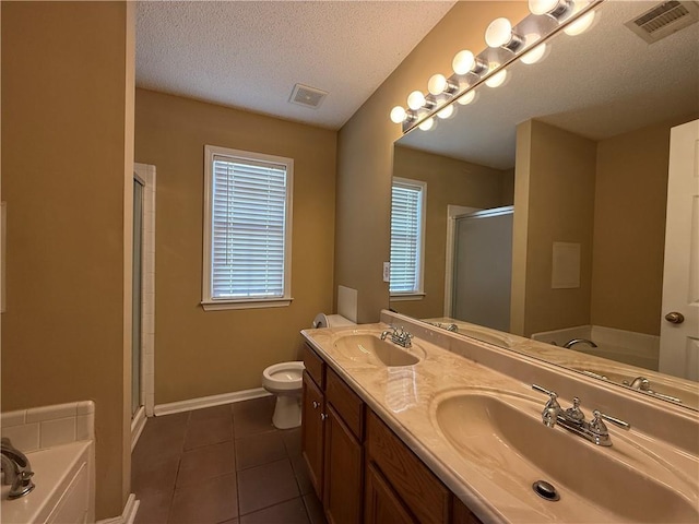 full bath with a stall shower, a sink, visible vents, and tile patterned floors