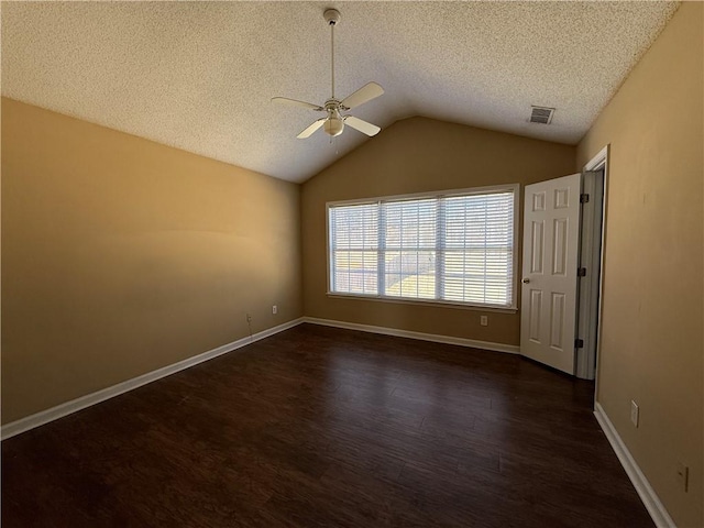 unfurnished room with dark wood finished floors, lofted ceiling, visible vents, a ceiling fan, and a textured ceiling