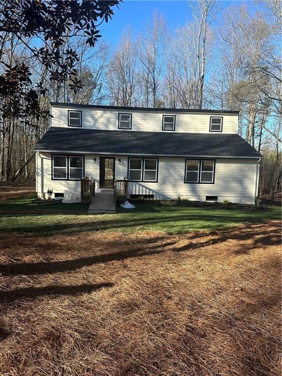 traditional-style house with a front lawn