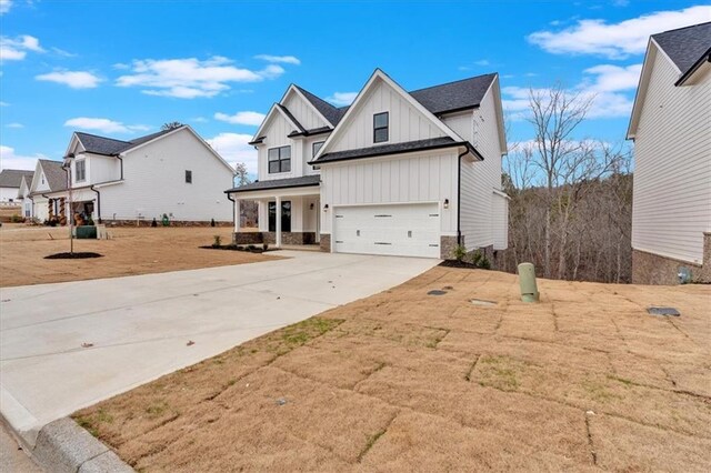 modern farmhouse with covered porch and a front lawn