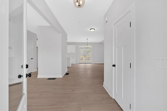 unfurnished living room with a fireplace, wood-type flooring, and ceiling fan with notable chandelier