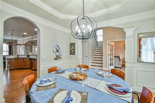 dining area featuring crown molding, a healthy amount of sunlight, and dark hardwood / wood-style floors