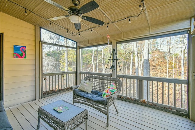 sunroom with ceiling fan, wooden ceiling, and vaulted ceiling