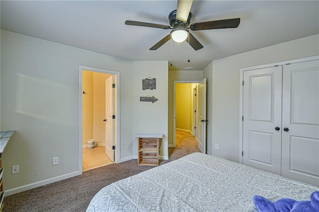 carpeted bedroom with ceiling fan, a closet, and ensuite bathroom