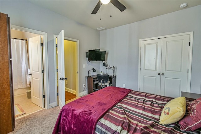 bedroom with ensuite bath, ceiling fan, a closet, and light carpet