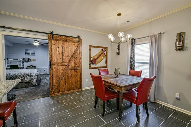 dining area with a barn door, ceiling fan with notable chandelier, and ornamental molding