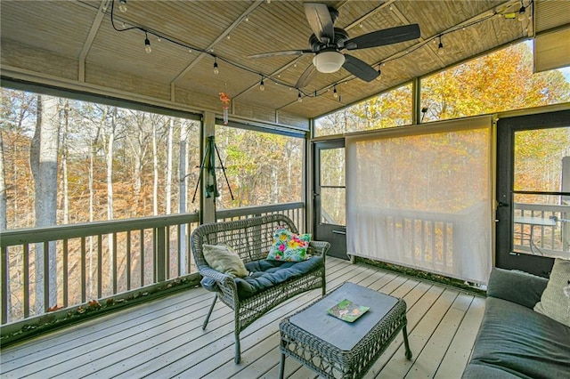 sunroom featuring ceiling fan and vaulted ceiling