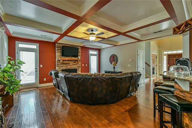 living room with dark hardwood / wood-style flooring, plenty of natural light, coffered ceiling, and ceiling fan