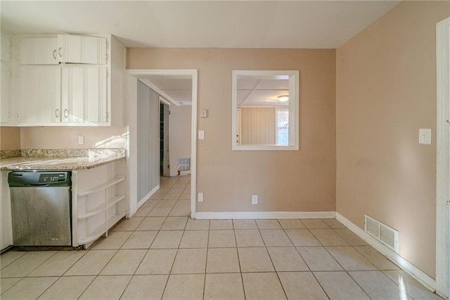 kitchen featuring dishwasher, white cabinetry, and light tile patterned flooring