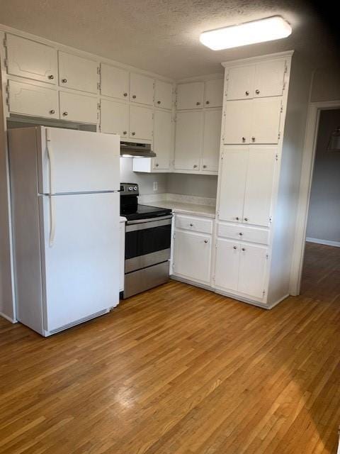 kitchen with stainless steel range with electric cooktop, white refrigerator, a textured ceiling, light hardwood / wood-style floors, and white cabinetry