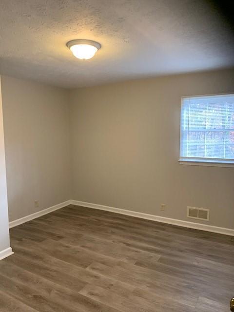 spare room with dark hardwood / wood-style floors