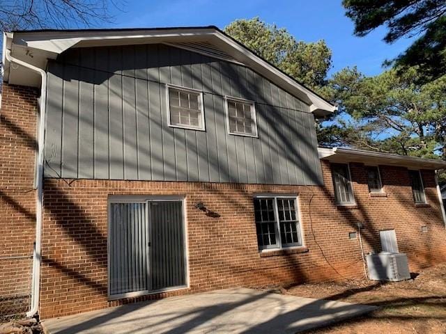 view of side of home with a patio area and central AC unit