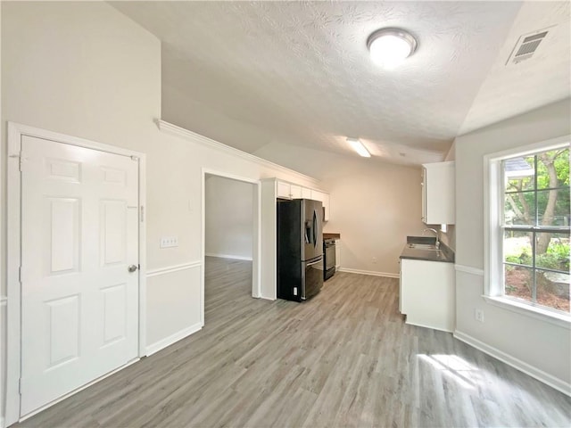 2012 Elm Grove Ln, Hampton, GA 30228 - kitchen featuring visible vents, a textured ceiling, white cabinets, stainless steel fridge with ice dispenser, and a sink