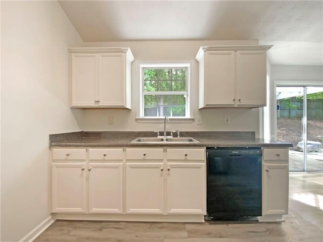 2012 Elm Grove Ln, Hampton, GA 30228 - kitchen featuring dark countertops, light wood-type flooring, dishwasher, a sink, and white cabinets