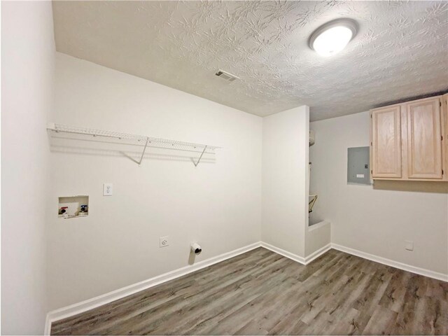 2012 Elm Grove Ln, Hampton, GA 30228 - laundry room featuring a textured ceiling, washer hookup, wood finished floors, and electric panel