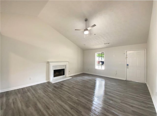 2012 Elm Grove Ln, Hampton, GA 30228 - unfurnished living room featuring a fireplace, a ceiling fan, baseboards, vaulted ceiling, and dark wood-style floors
