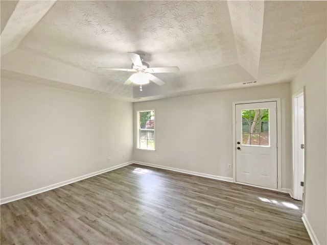 2012 Elm Grove Ln, Hampton, GA 30228 - unfurnished room featuring baseboards, a textured ceiling, a raised ceiling, and wood finished floors