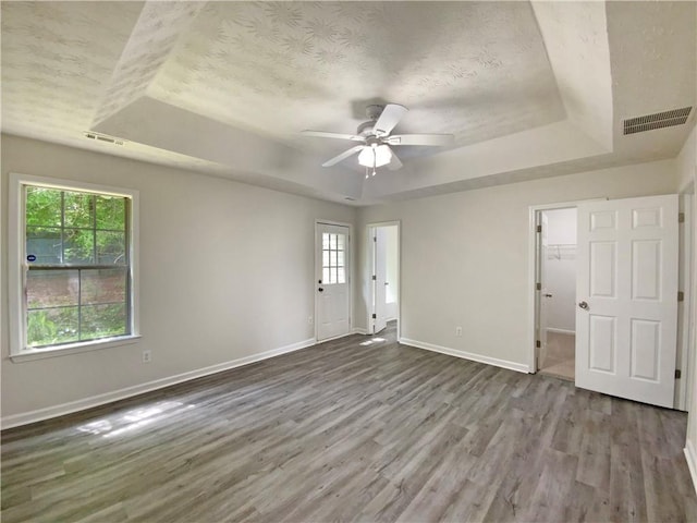 2012 Elm Grove Ln, Hampton, GA 30228 - interior space with visible vents, a healthy amount of sunlight, wood finished floors, and a raised ceiling