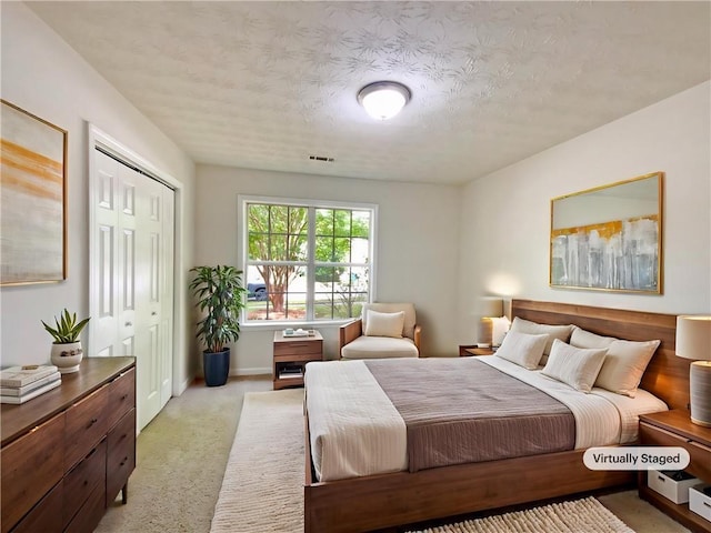 2012 Elm Grove Ln, Hampton, GA 30228 - bedroom with a textured ceiling, visible vents, baseboards, a closet, and light carpet