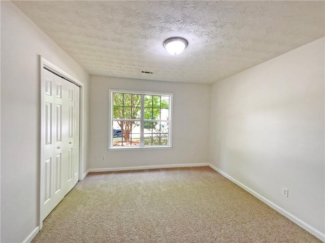 2012 Elm Grove Ln, Hampton, GA 30228 - unfurnished bedroom featuring baseboards, carpet floors, a textured ceiling, and visible vents